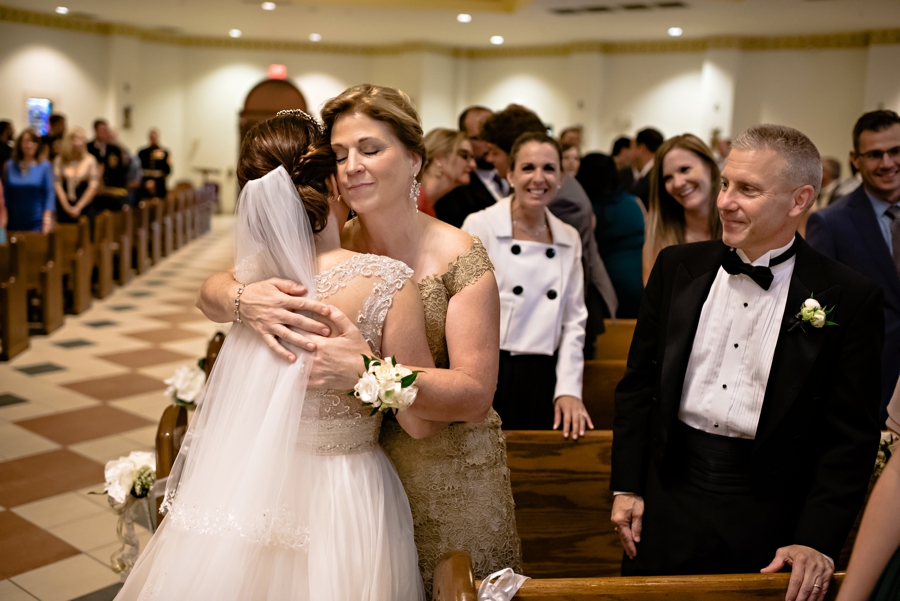 A daughter hugs her mother during the offering of piece at her Philadelphia wedding.